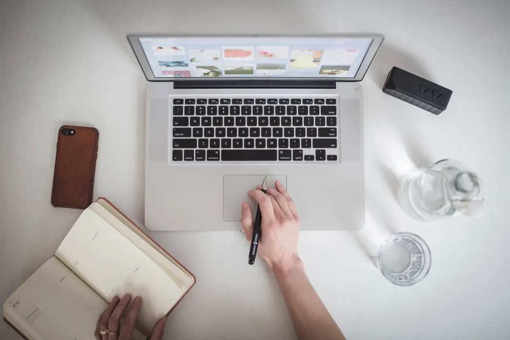 Parent checking a laptop at home, representing the PowerSchool parent portal in Derby
