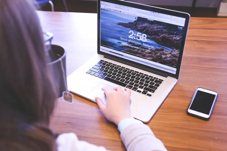 Student studying with a laptop, showing Derby student resources in use