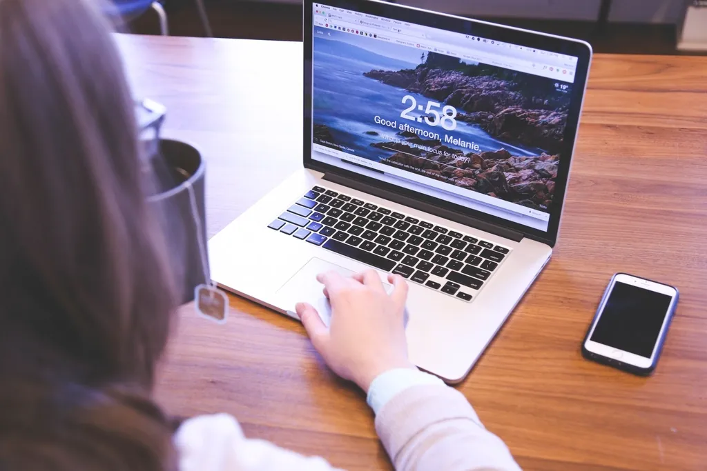 Student studying with a laptop, showing Derby student resources in use